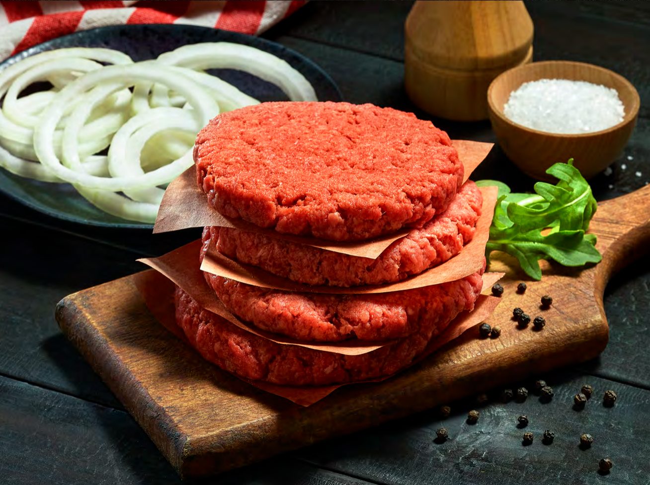 Stack of raw grass-fed beef patties