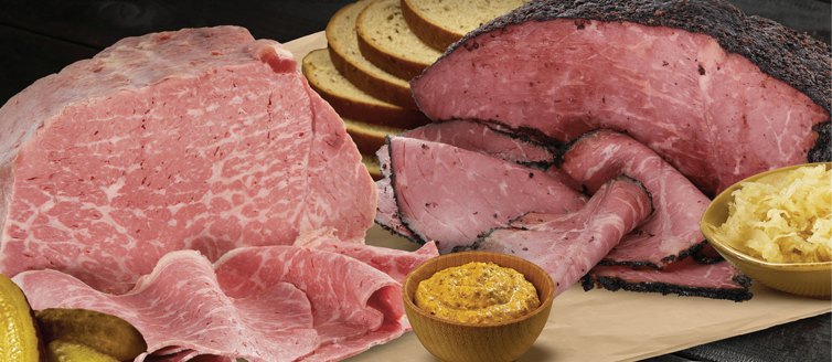 Sliced Wagyu corned beef and Wagyu pastrami with rye bread, mustard and sauerkraut