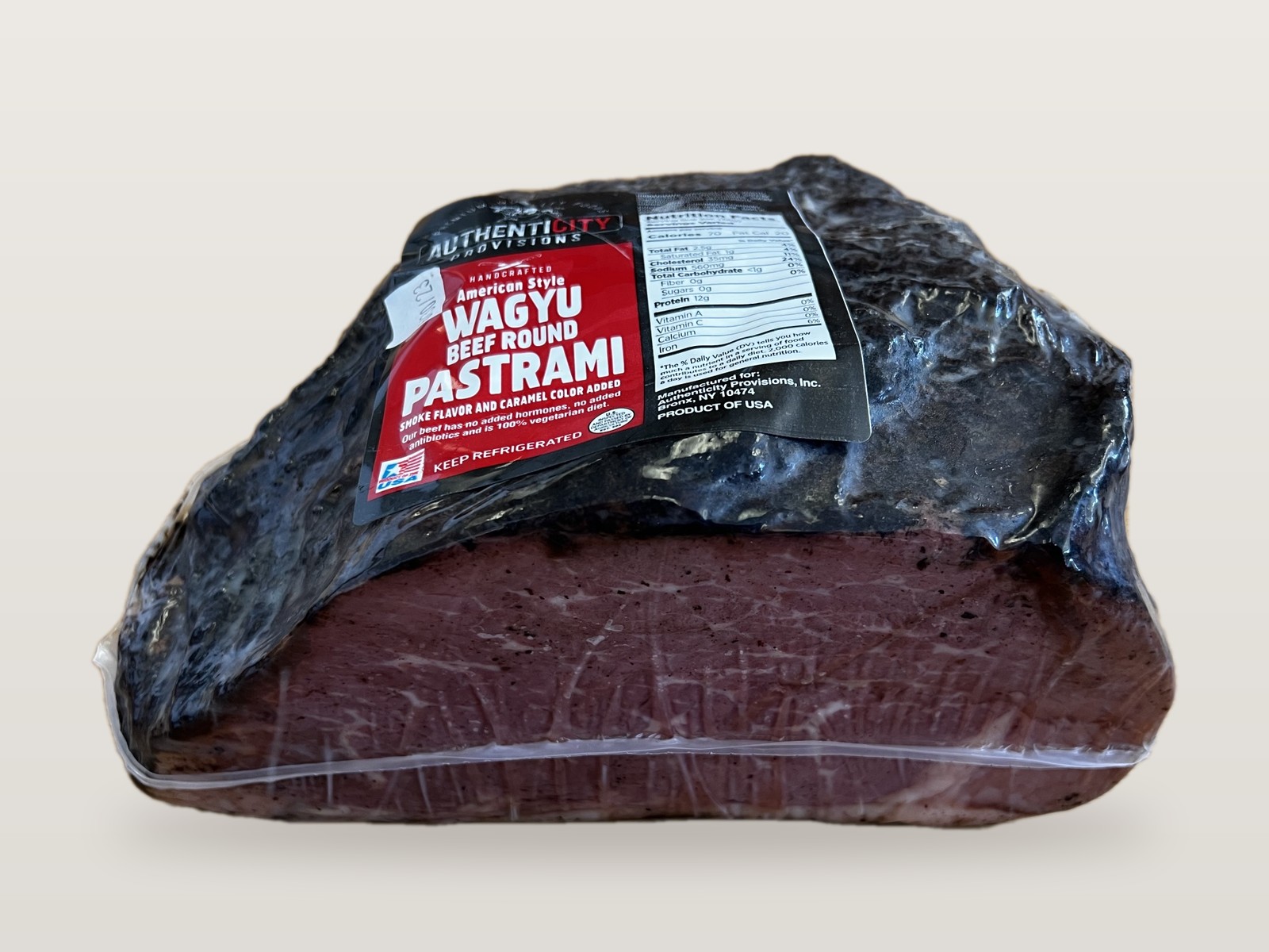 AuthentiCITY Provisions Wagyu Beef Round Pastrami, vacuum packed, showing the peppered crust and cut face